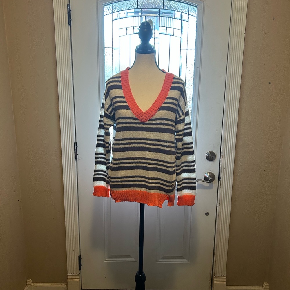 Miss Daisy women’s striped sweater with elbow patches and button accents.
